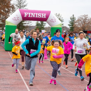 Two Girls on the Run Coaches smile while running 